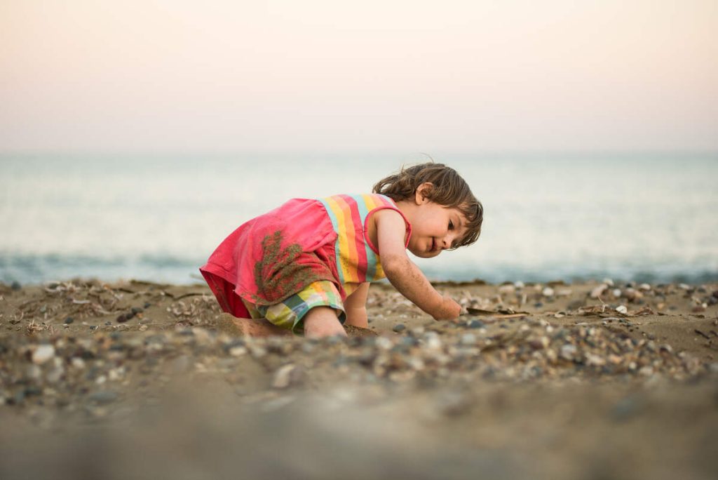 toddler on the beach wearing custom summer clothes
