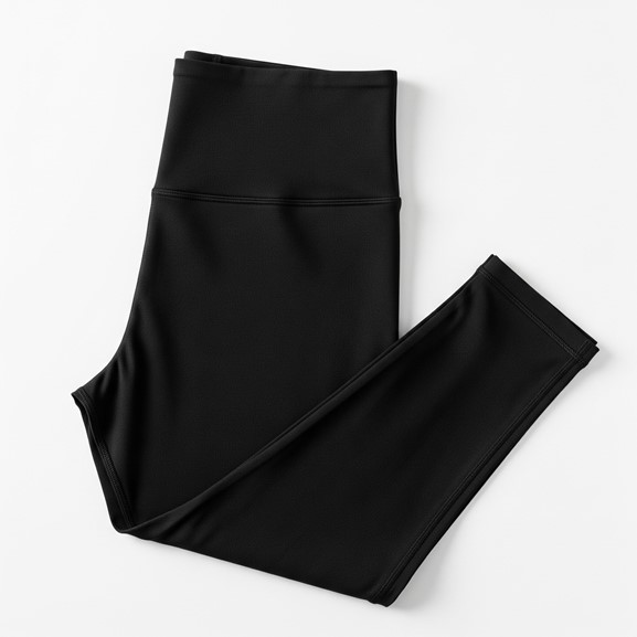 Black high-waisted leggings laid flat on a white surface. The fabric appears smooth and stretchy, suggesting comfort and flexibility.