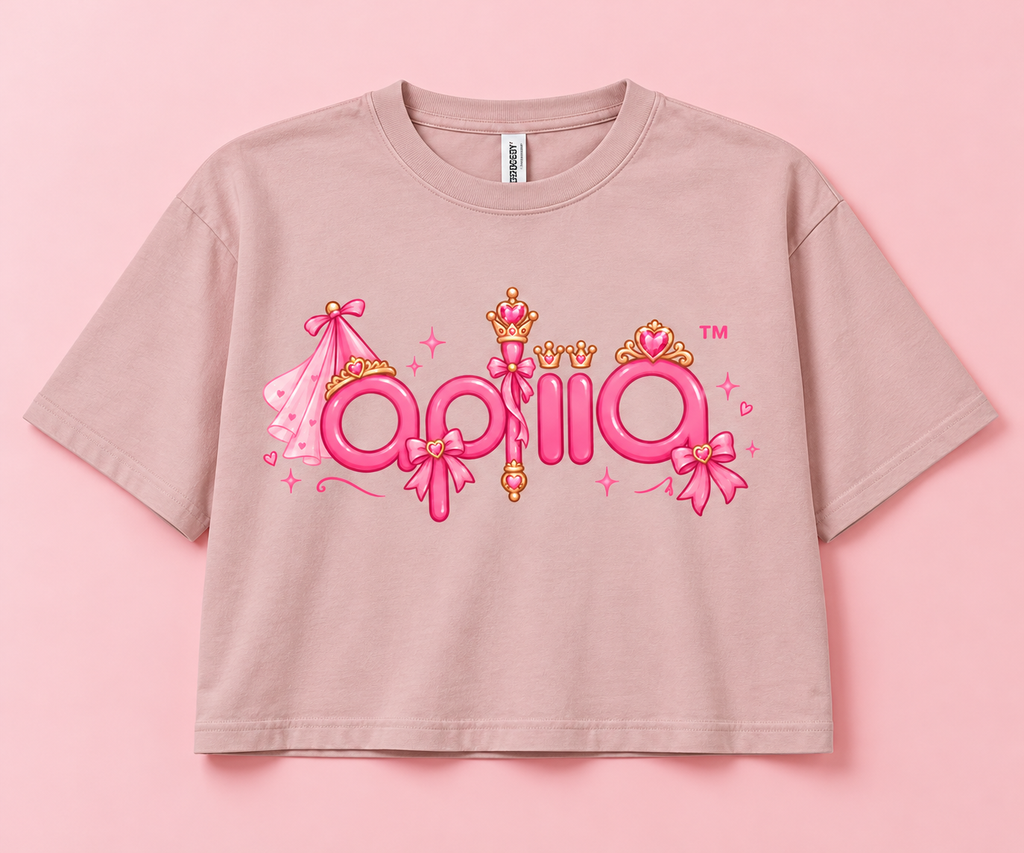 Apliiq princess logo printed on a pink cropped T-shirt with crowns, bows, hearts, and sparkles
